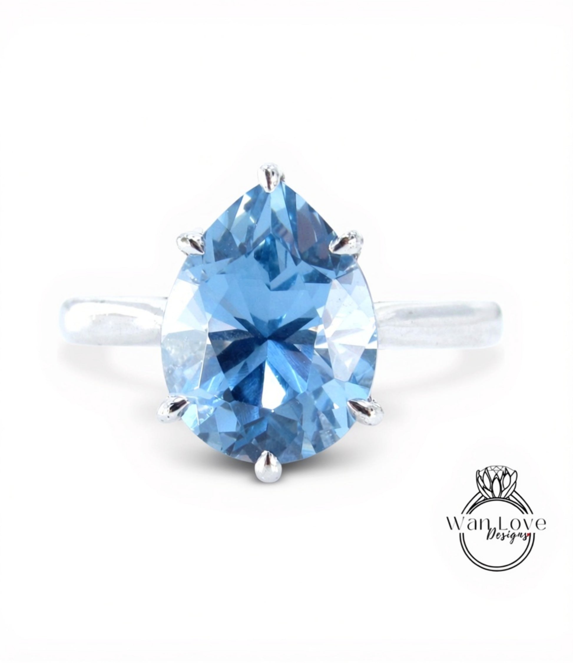 A close-up image of a blue diamond ring with a large, clear gemstone set in a silver band.