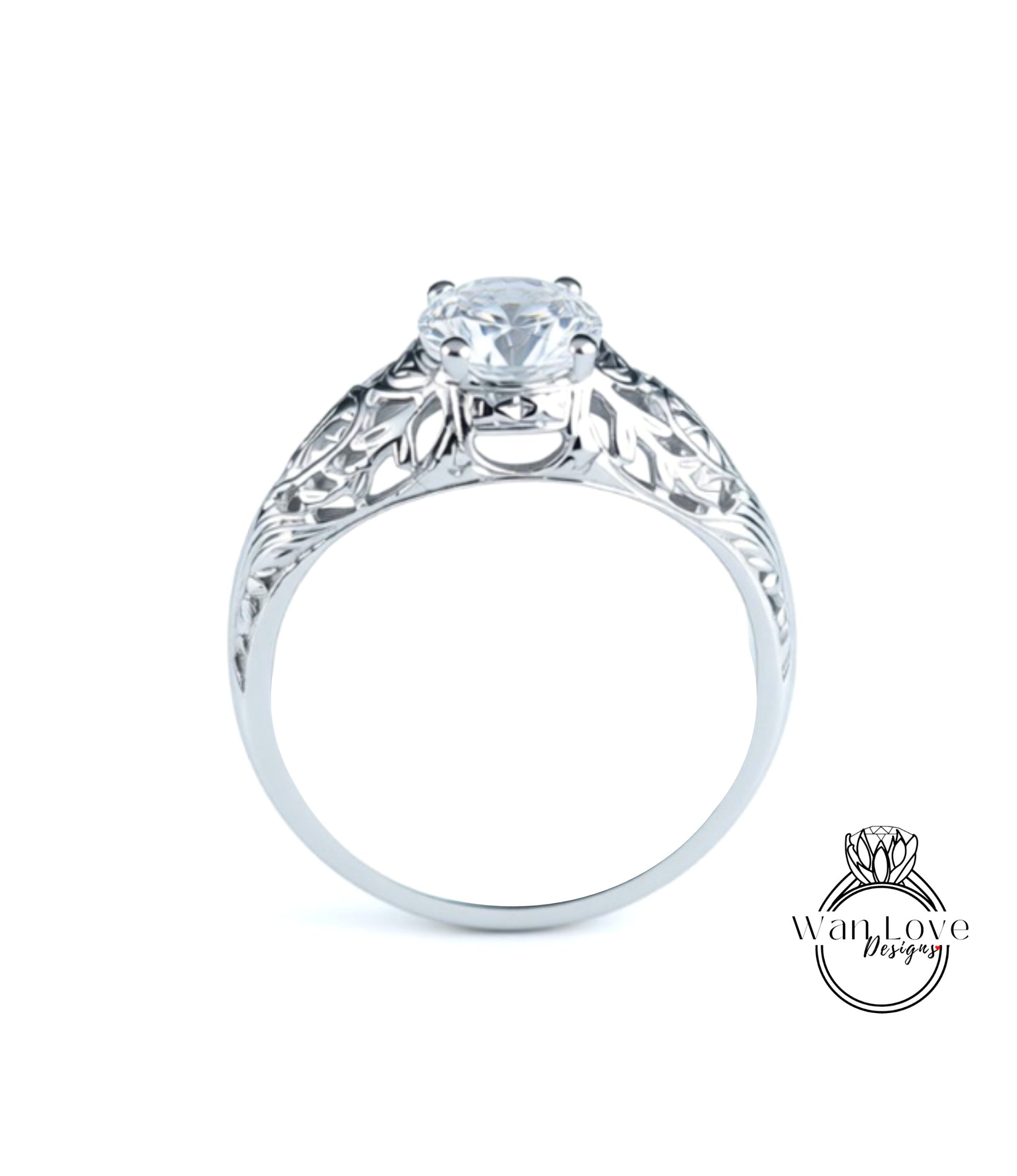 A close-up view of a silver engagement ring with a large central diamond and intricate floral designs around the band.