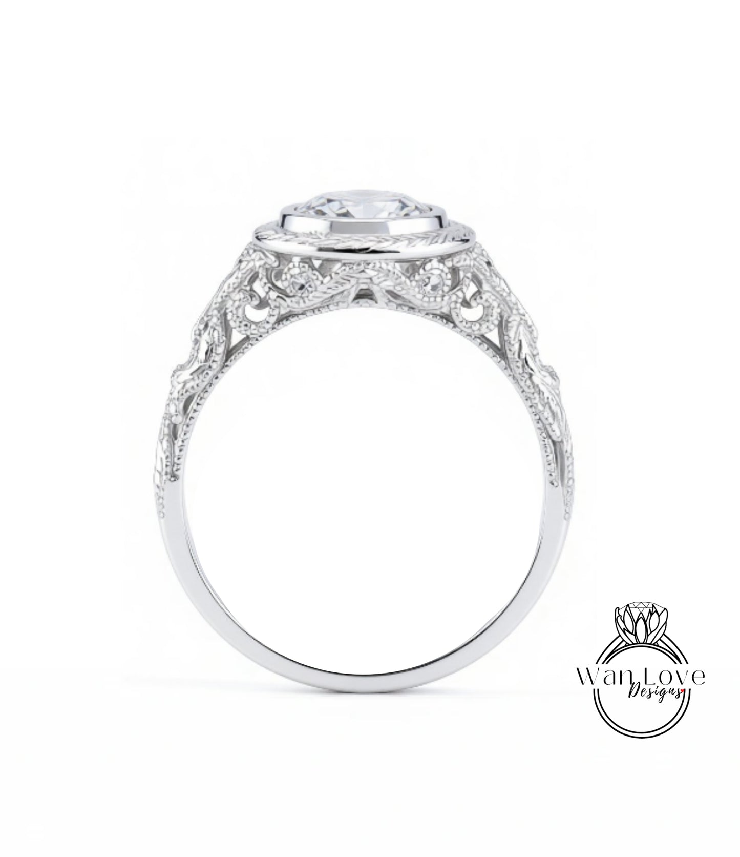 A close-up view of a silver ring with an intricate, decorative design around the band and a large central stone.