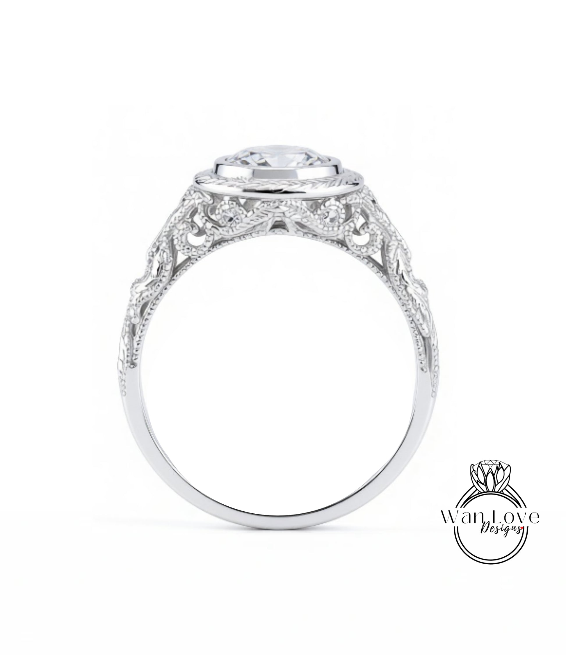 A close-up view of a silver ring with an intricate, decorative design around the band and a large central stone.