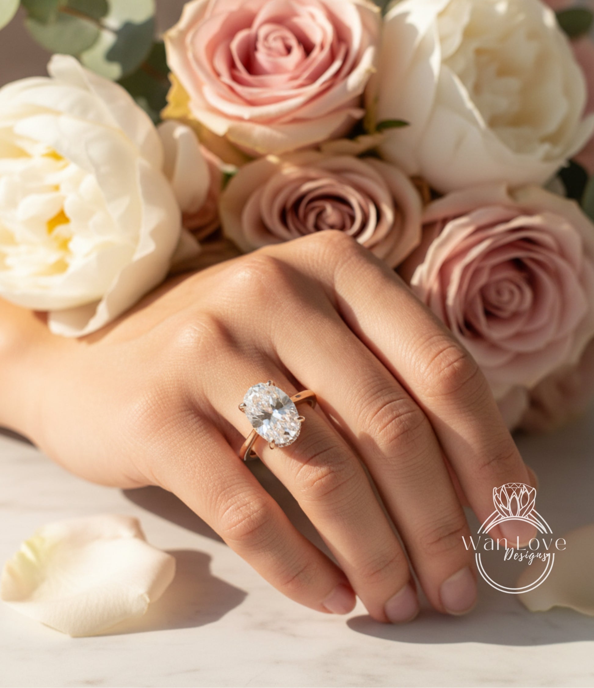 A close-up of a hand wearing a large diamond engagement ring, with a bouquet of pink and white roses in the background.