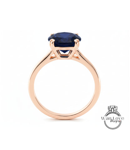 A gold ring with a large blue gemstone set in the center.