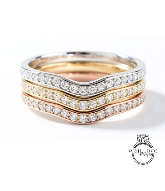 A ring with a diamond band in three different colors: silver, gold, and rose gold.
