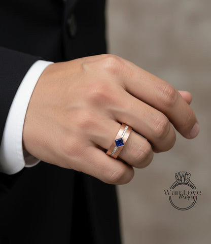 A close-up of a person's hand wearing a gold ring with a blue gemstone.