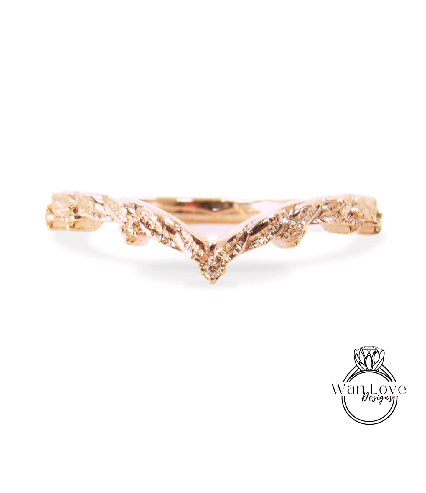 A gold ring with a leaf-like design on the band.