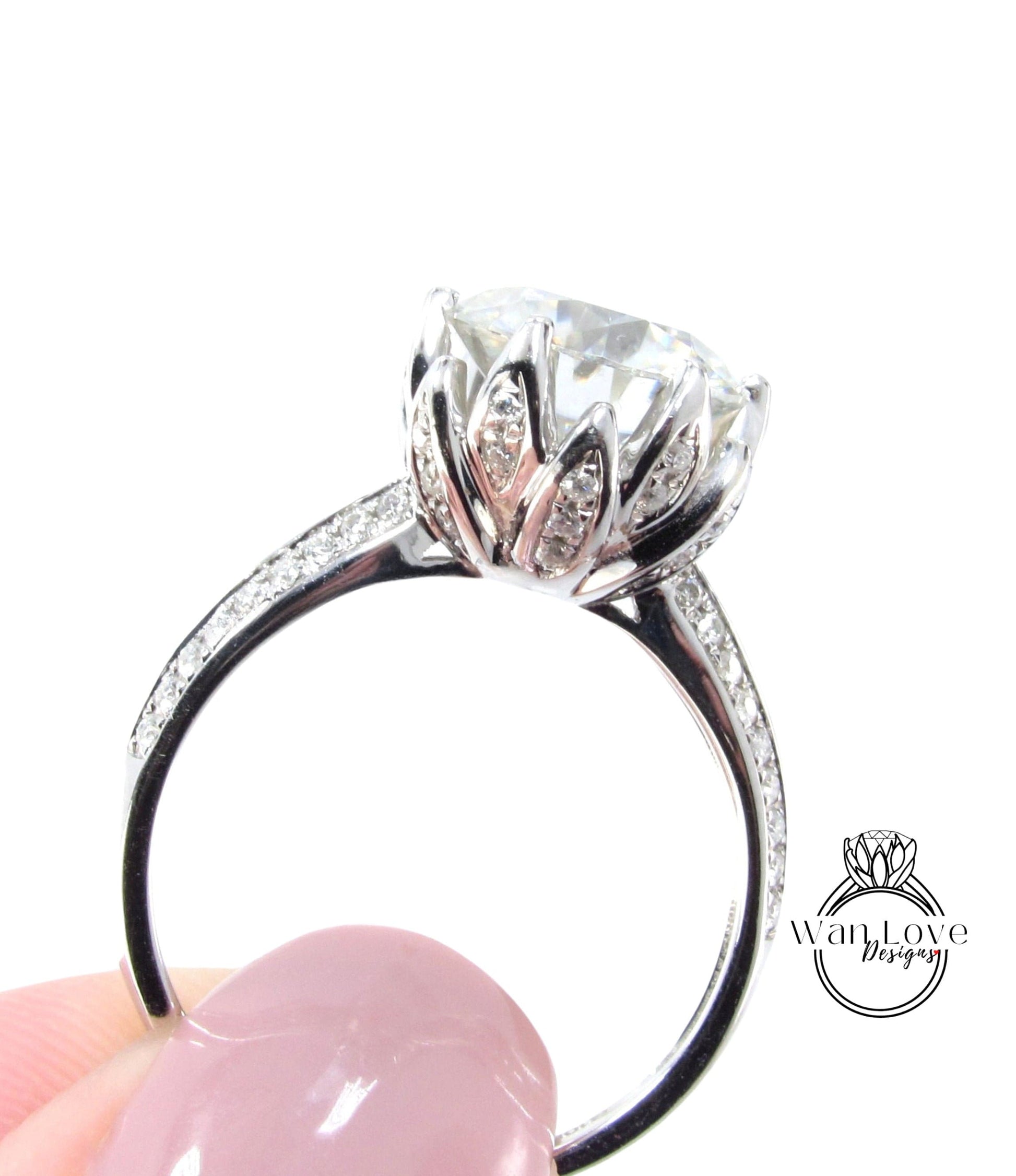 A close-up of a silver ring with a large, clear gemstone, possibly a diamond, set in a decorative metal band.