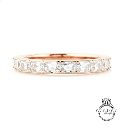 A rose gold band with a row of clear gemstones, likely diamonds, set in the center.