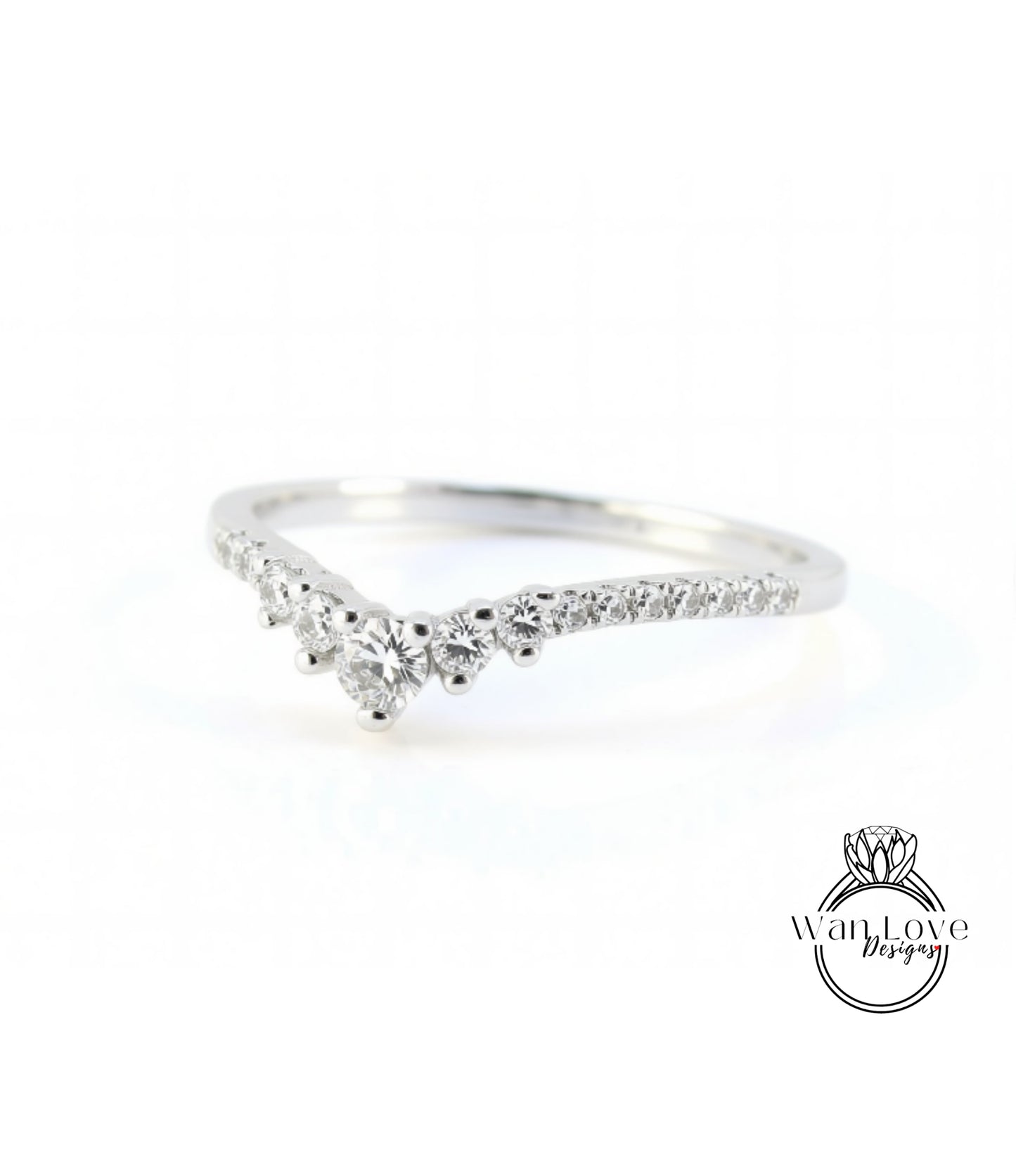 A silver ring with a diamond-encrusted band, featuring a v-shaped design with multiple small diamonds set in the center.