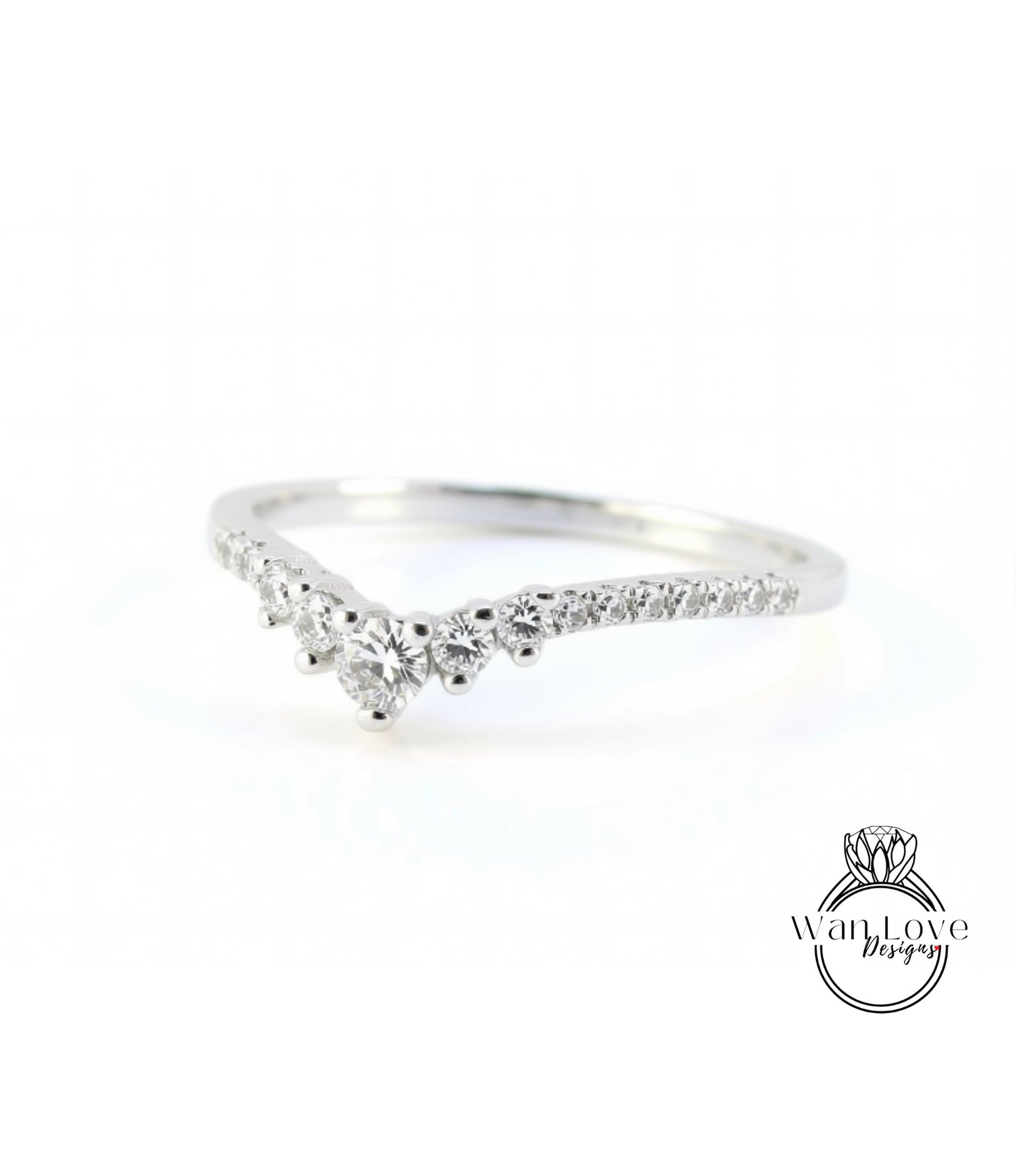 A silver ring with a diamond-encrusted band, featuring a v-shaped design with multiple small diamonds set in the center.