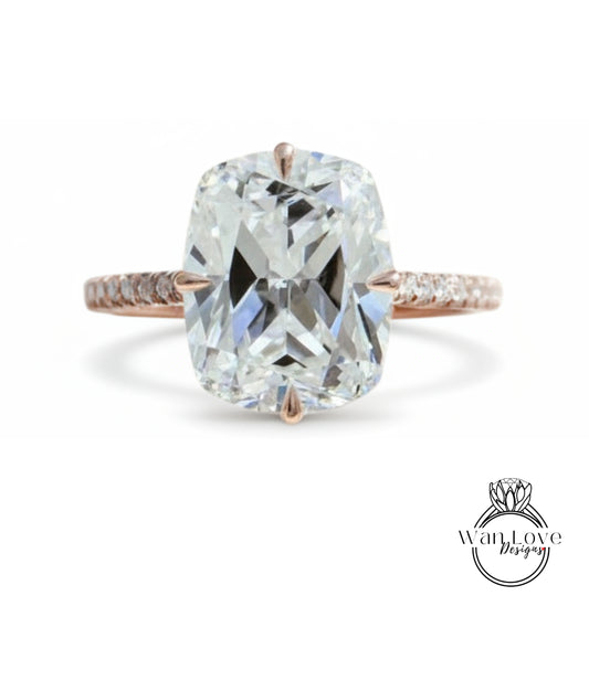 A large, clear diamond engagement ring with a rose gold band and a large central diamond.