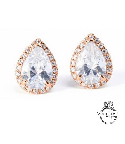 A pair of elegant earrings with large, clear gemstones set in a delicate gold-toned frame.