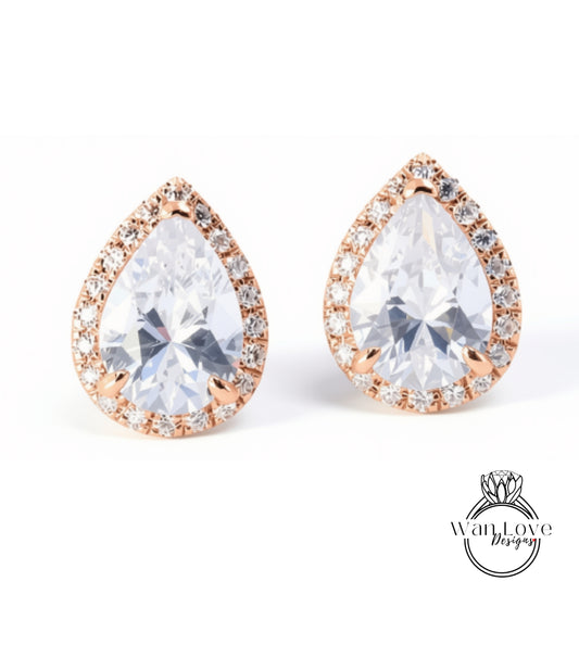 A pair of elegant earrings with large, clear gemstones set in a delicate gold-toned frame.