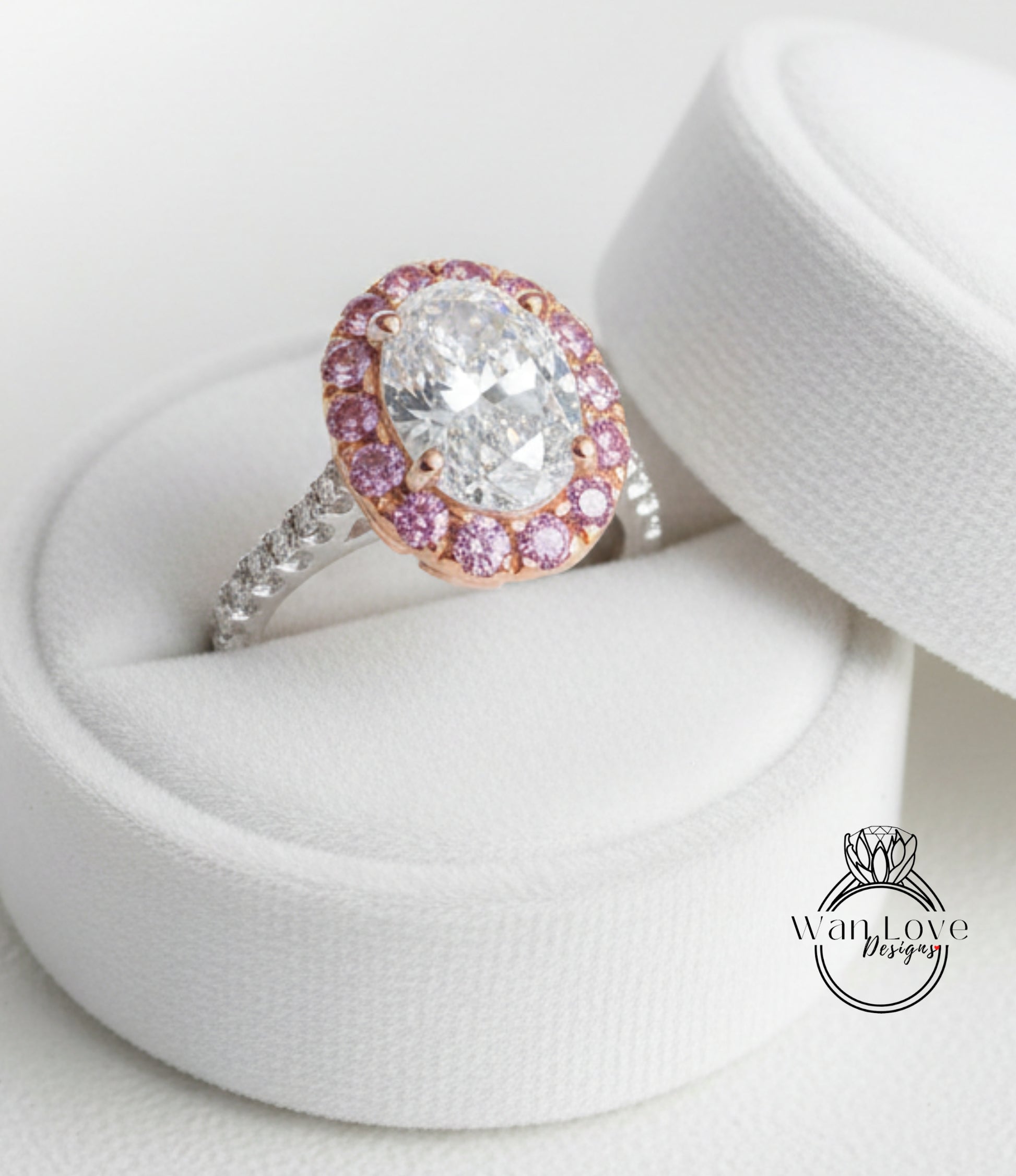 A stunning diamond engagement ring with a large oval-shaped diamond surrounded by a halo of smaller diamonds and set in a silver band, displayed in a white jewelry box.