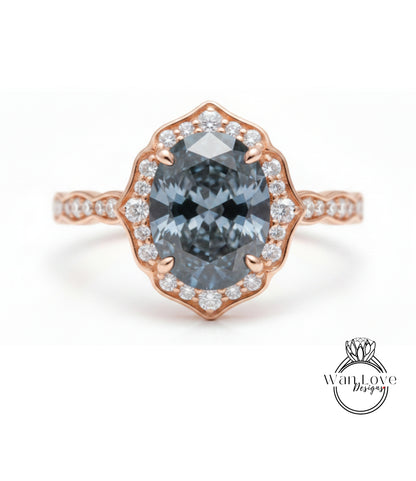 A rose gold ring with a large oval-shaped blue gemstone set in the center, surrounded by smaller diamonds.