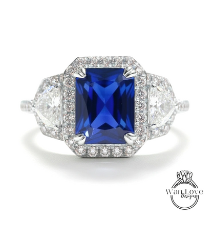 A stunning engagement ring with a large blue gemstone surrounded by smaller diamonds, set in a halo of smaller diamonds.