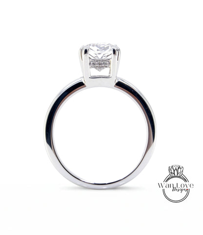 A silver engagement ring with a large diamond set in the center.