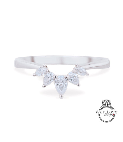 A silver ring with a large, clear gemstone set in the center, surrounded by smaller, clear gemstones.