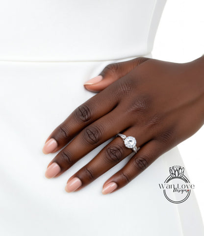 A close-up of a hand wearing a diamond engagement ring.