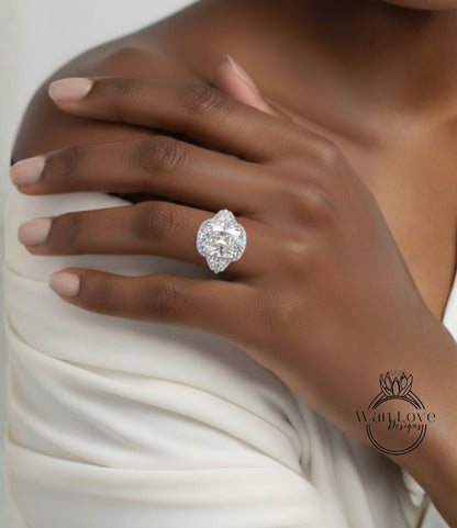 A close-up of a person's hand wearing a large, sparkling diamond ring.