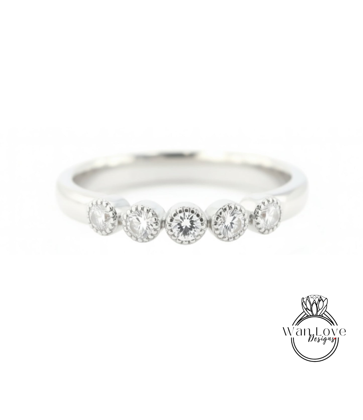 A silver ring with a row of five round diamonds set in the band.