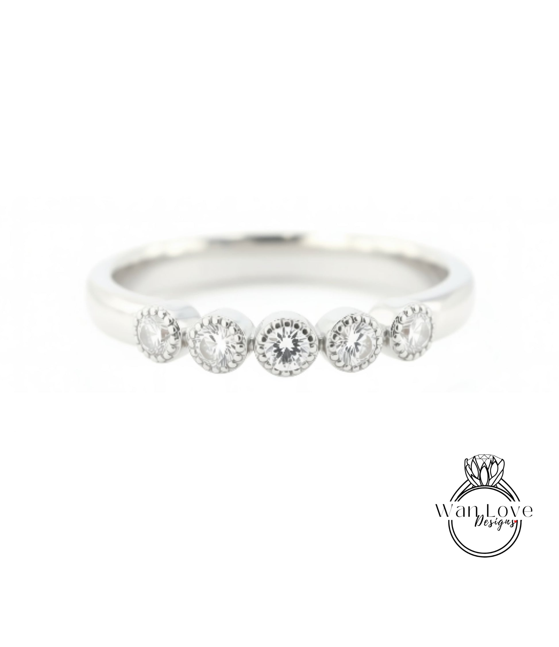 A silver ring with a row of five round diamonds set in the band.