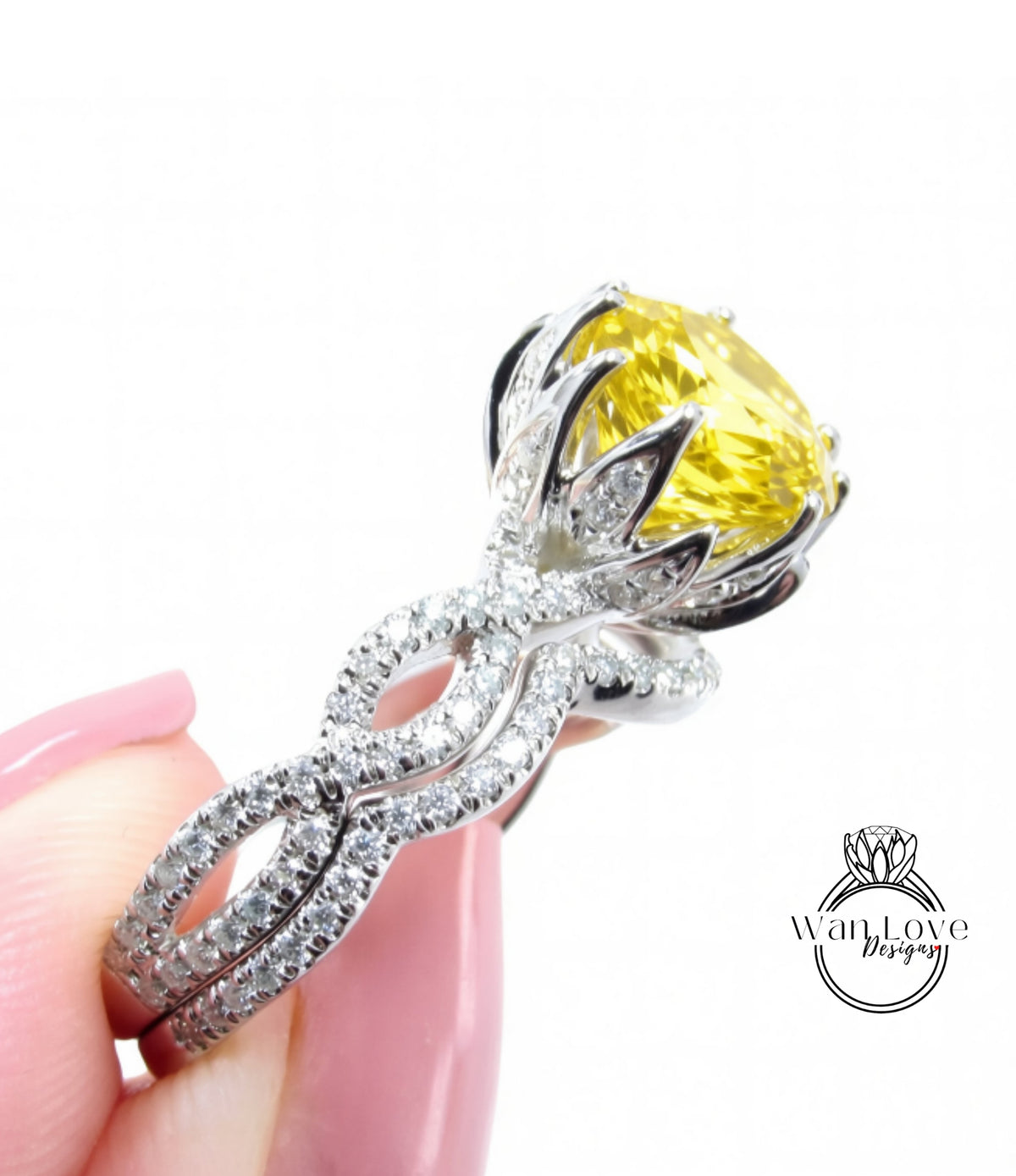 A close-up of a diamond engagement ring with a large yellow gemstone set in a silver band.