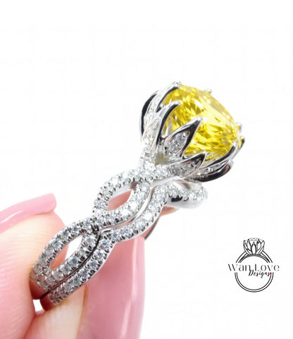 A close-up of a diamond engagement ring with a large yellow gemstone set in a silver band.