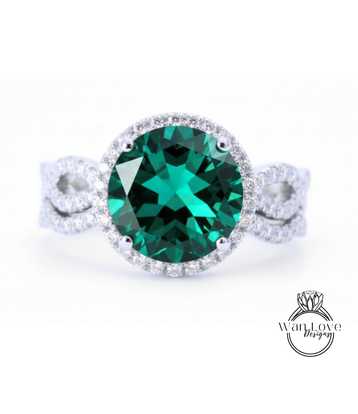 A large oval-shaped green gemstone set in a silver ring with a halo of smaller diamonds around the edge.