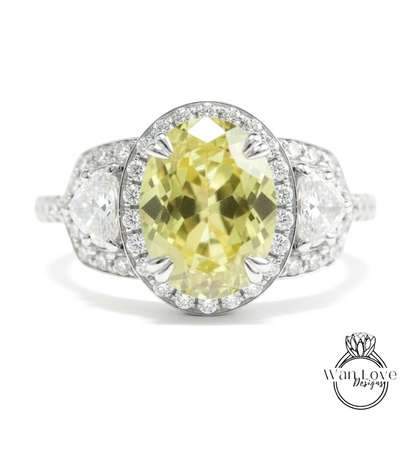 A close-up of a diamond engagement ring with a large oval-shaped yellow gemstone surrounded by smaller diamonds.