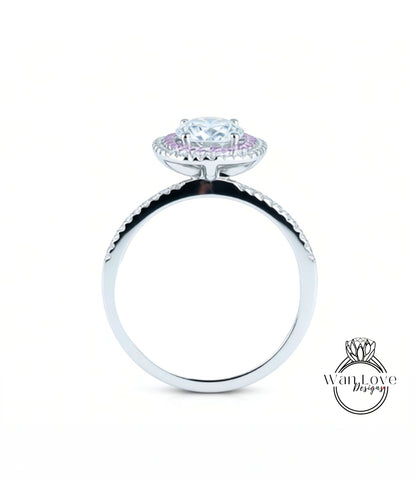 A silver engagement ring with a large central diamond surrounded by smaller diamonds, set in a halo of smaller diamonds.