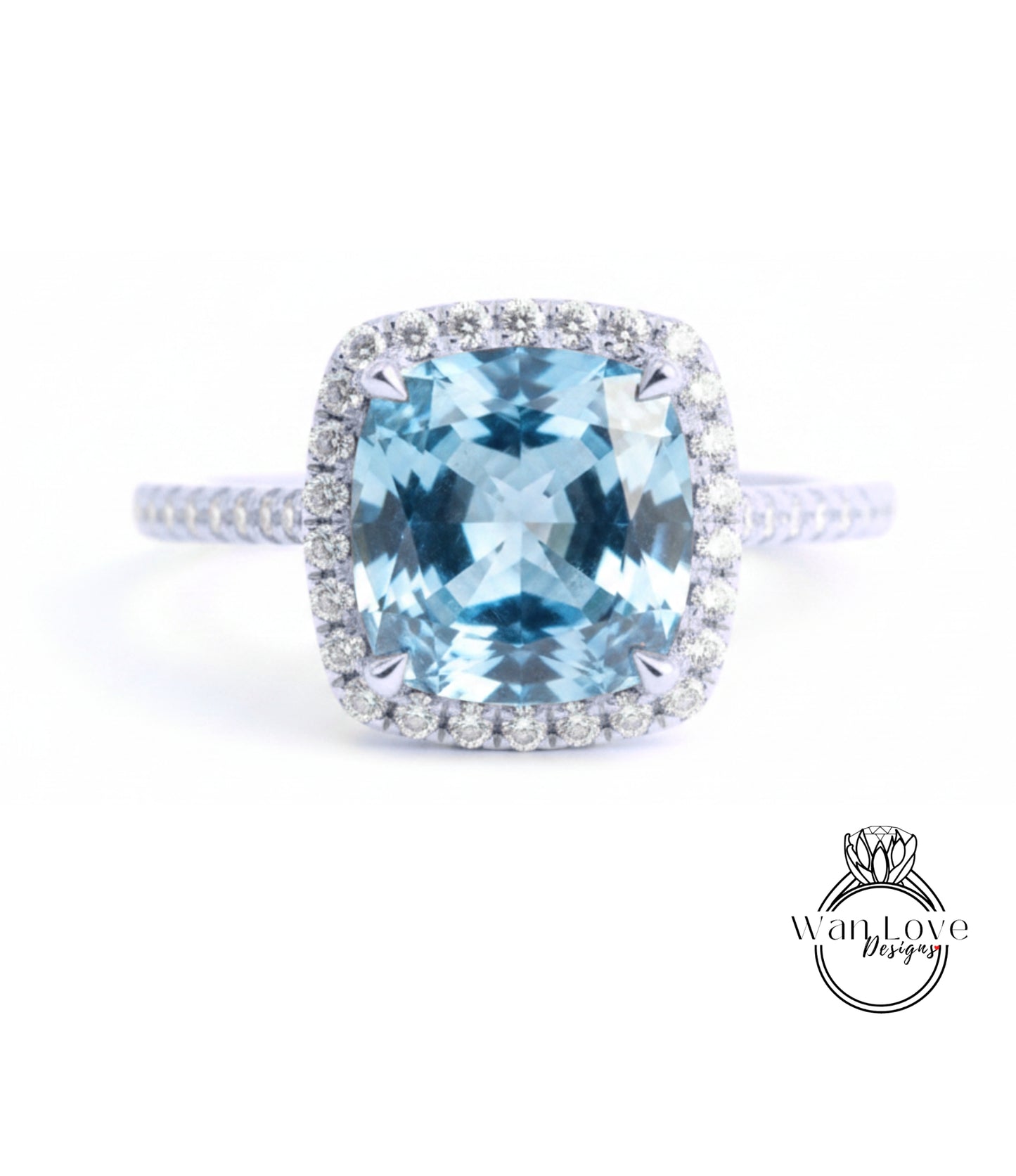 A stunning blue gemstone ring with a halo of diamonds around the center stone.
