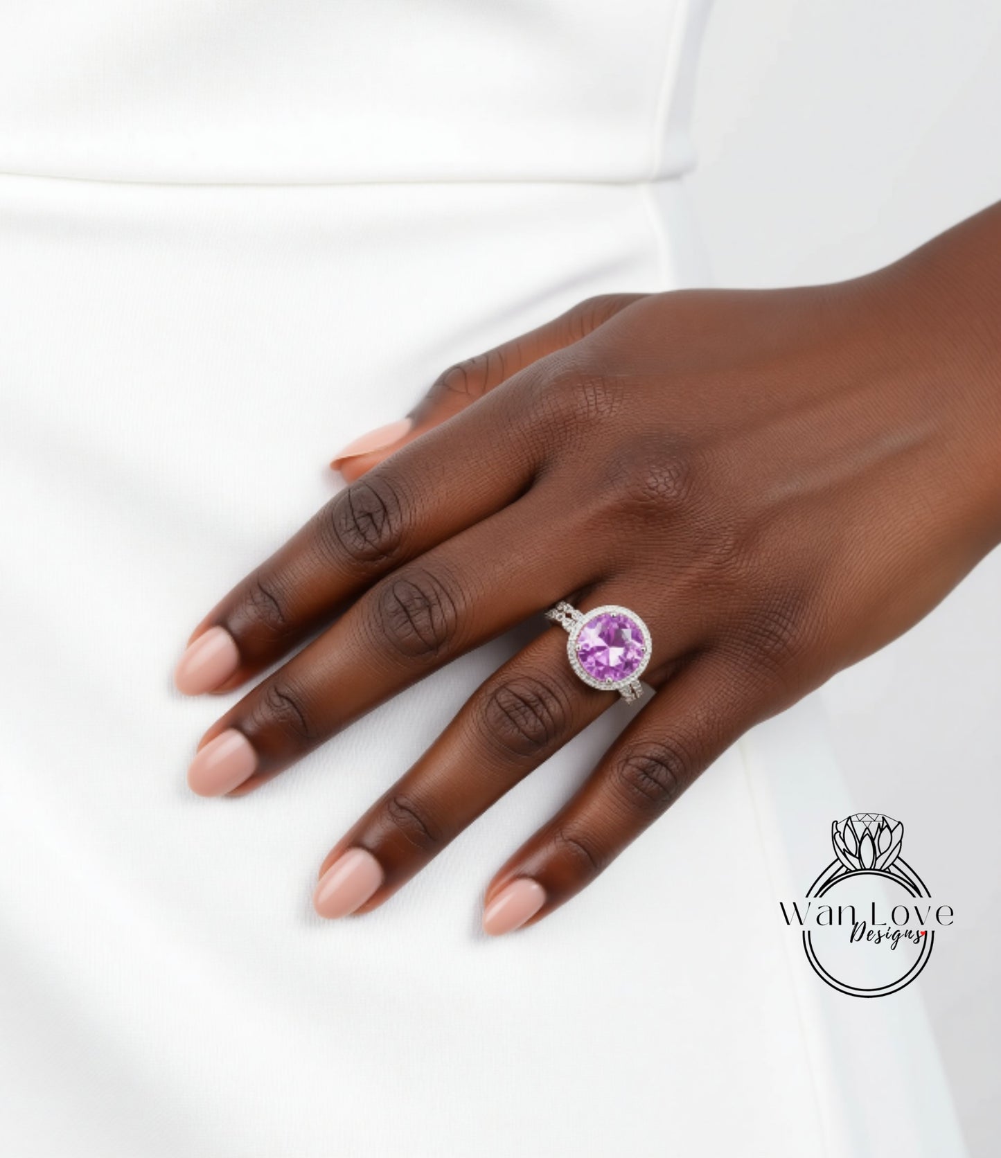 A close-up of a hand wearing a ring with a large purple gemstone.