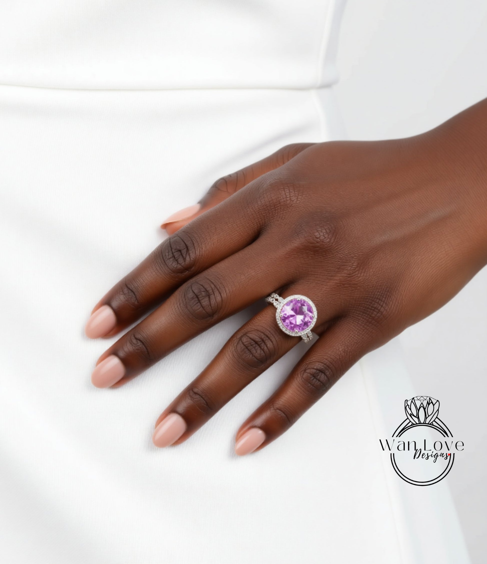 A close-up of a hand wearing a ring with a large purple gemstone.