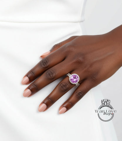 A close-up of a hand wearing a ring with a large purple gemstone.
