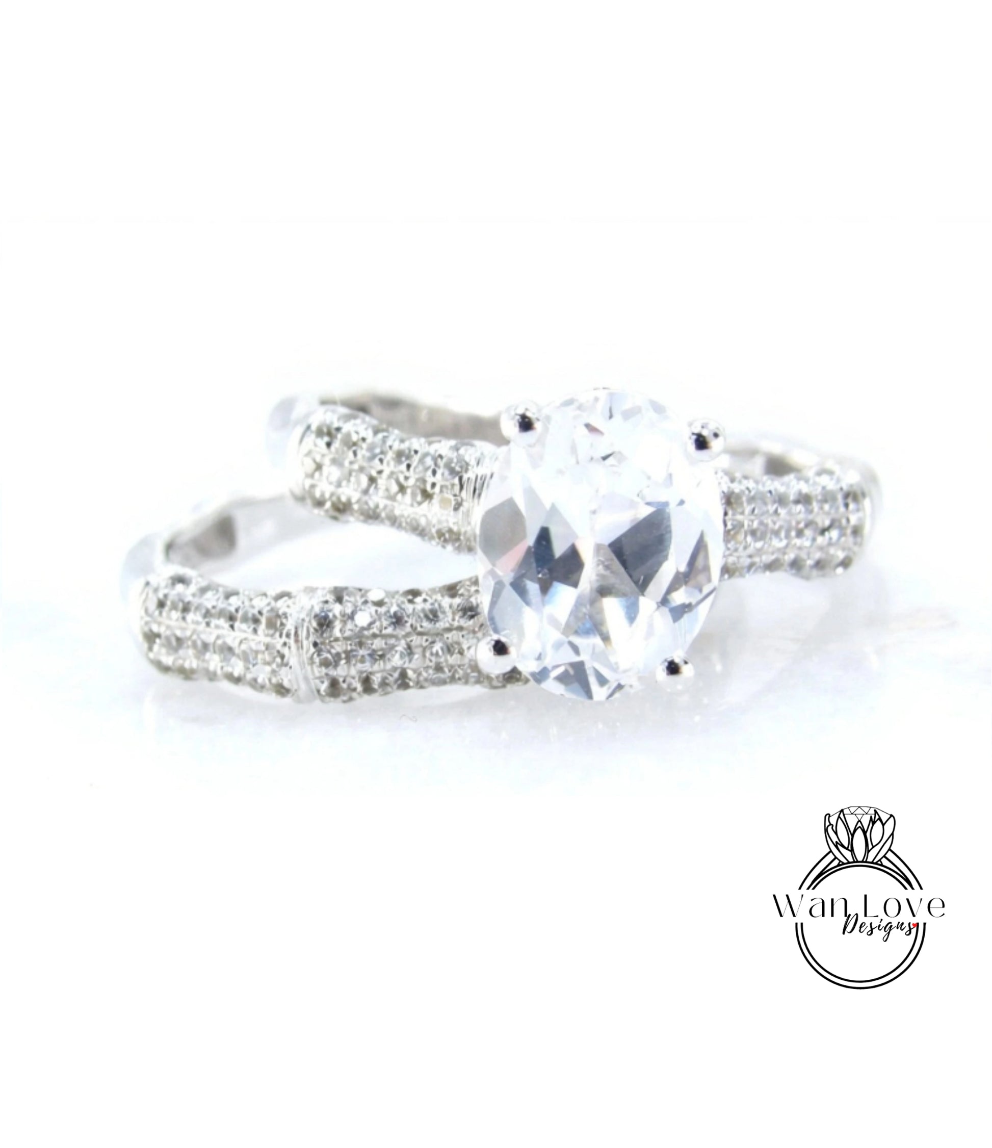 A close-up view of a diamond engagement ring with a large central diamond surrounded by smaller diamonds on either side.