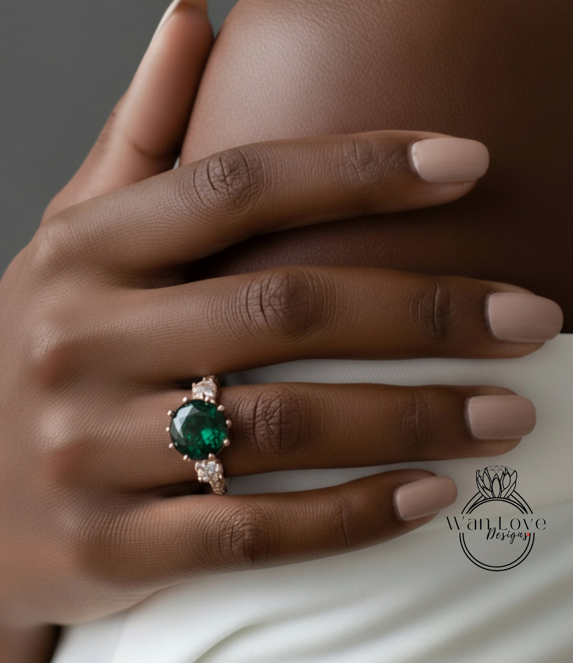 A close-up of a person's hand wearing a ring with a large green gemstone.