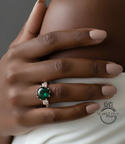 A close-up of a person's hand wearing a ring with a large green gemstone.