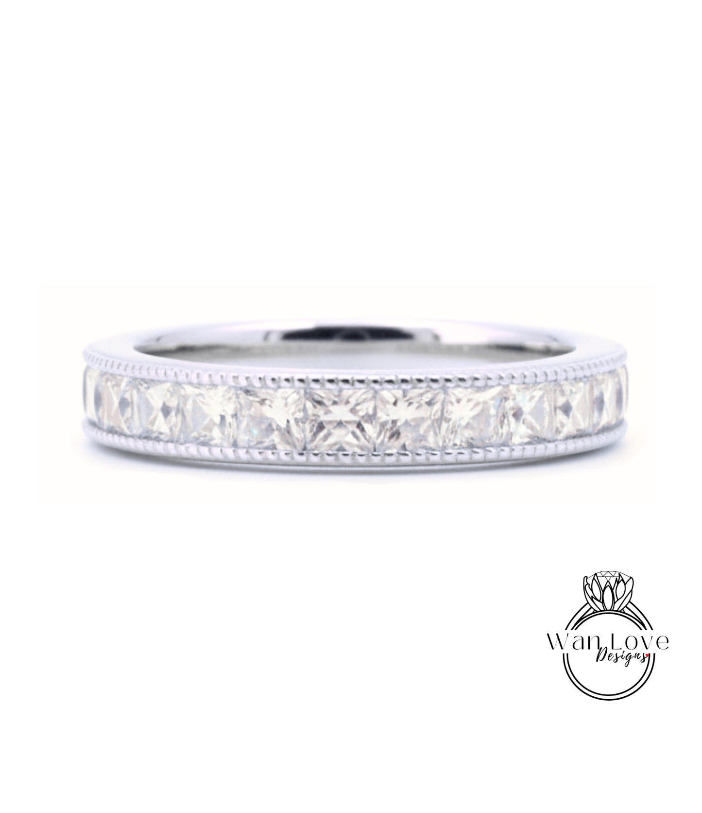 A silver band ring with a row of clear gemstones, likely diamonds, set in a decorative pattern.