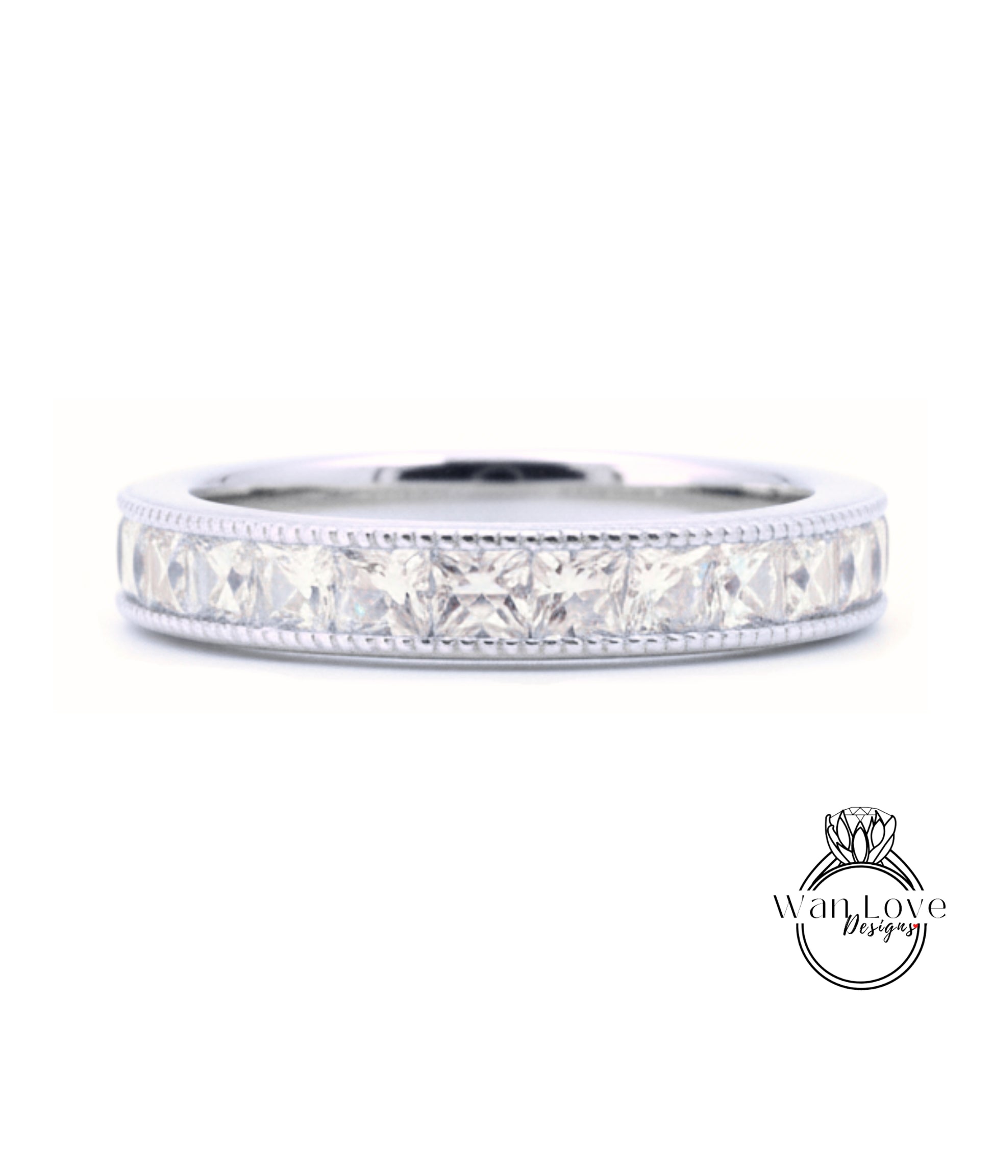 A silver band ring with a row of clear gemstones, likely diamonds, set in a decorative pattern.