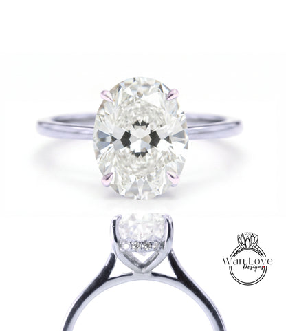 A close-up of a diamond engagement ring with a large oval-shaped diamond set in a silver band.