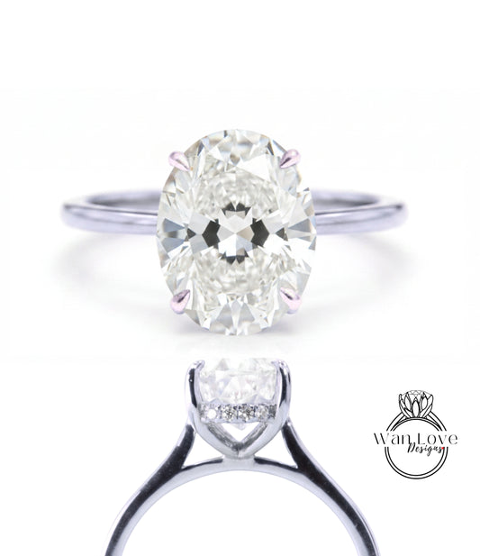 A close-up of a diamond engagement ring with a large oval-shaped diamond set in a silver band.