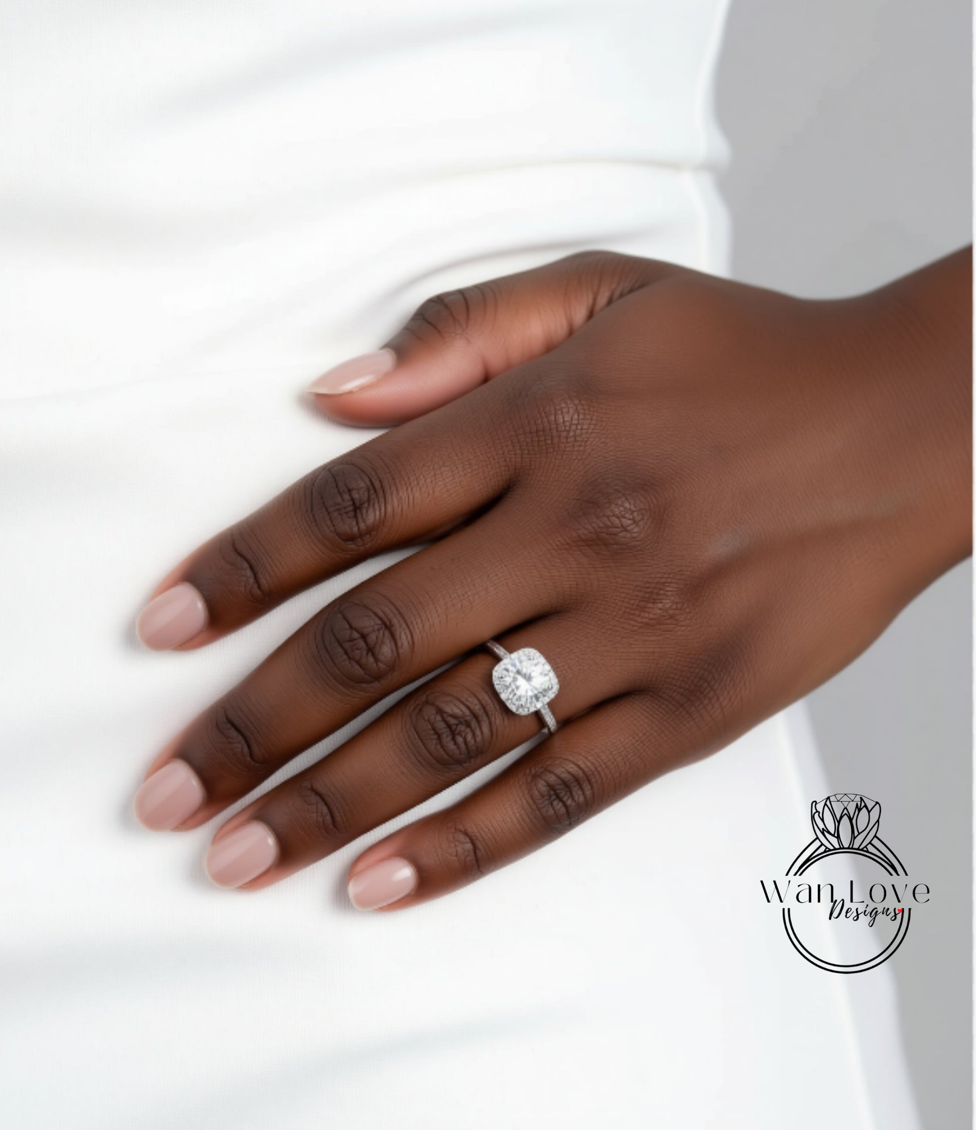 A close-up of a hand wearing a diamond engagement ring.
