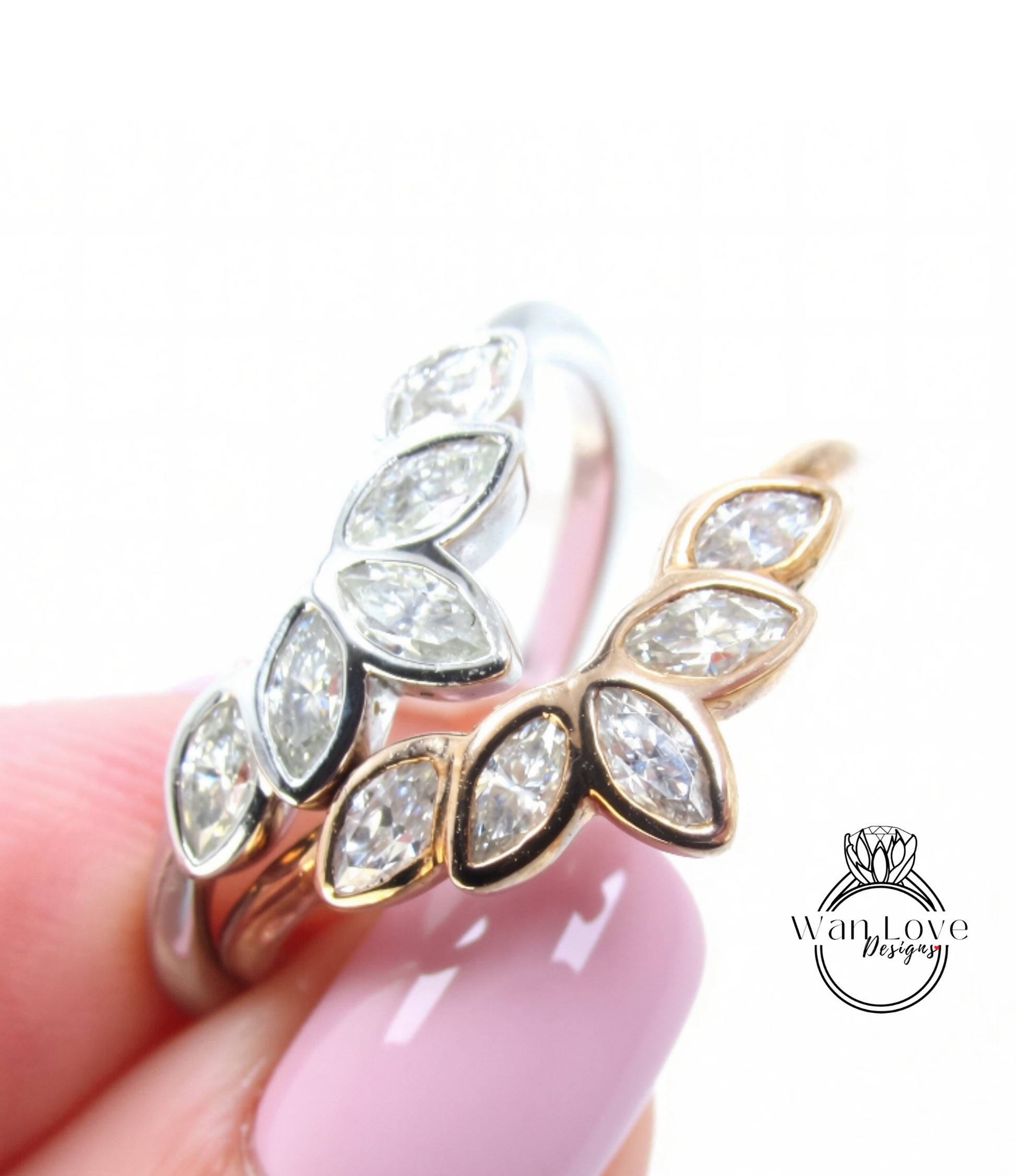 A close-up of a hand holding a ring with a floral design, featuring multiple small diamonds.