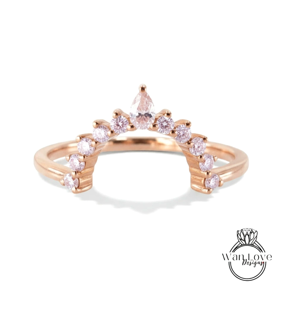 A rose gold ring with a unique design featuring a central diamond surrounded by smaller diamonds arranged in a fan-like pattern.