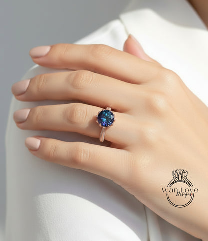 A close-up of a person's hand wearing a ring with a blue gemstone.