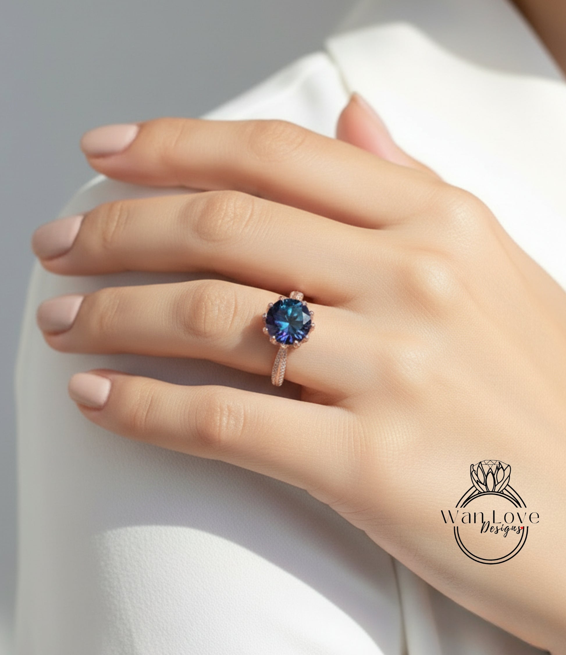 A close-up of a person's hand wearing a ring with a blue gemstone.