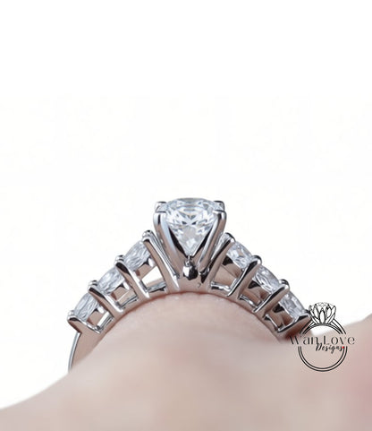 A close-up view of a diamond engagement ring on a person's hand, showcasing the intricate design and sparkling gemstone.