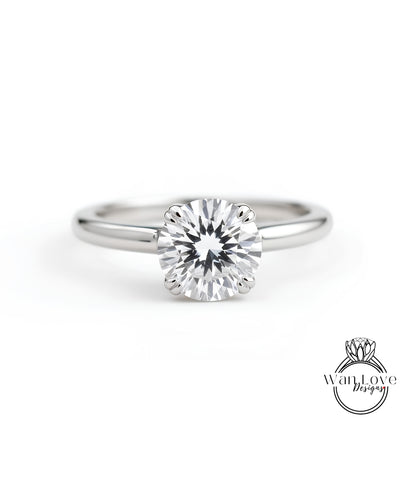 A close-up view of a diamond engagement ring with a large, brilliant-cut diamond set in a silver band.