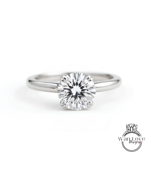 A close-up view of a diamond engagement ring with a large, brilliant-cut diamond set in a silver band.
