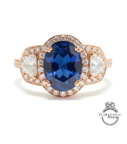 A close-up of a gold ring with a large blue gemstone at the center, surrounded by smaller diamonds.